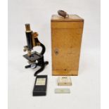 A vintage black lacquered “Kima” monocular microscope with wooden case by W. Watson & Sons of London