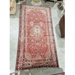 North West Persian Malayer red ground carpet with central floral lozenge on floral field with floral