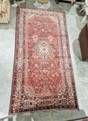 North West Persian Malayer red ground carpet with central floral lozenge on floral field with floral