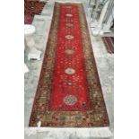 Large Russian Kazak red ground runner with seven elephant foot guls on stylized geometric pattern