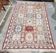 Modern Moroccan cream ground rug with three rows of six of alternating square floral pattern