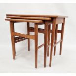 Nest of three mid-century teak side tables of rectangular form, raised on turned tapering legs,