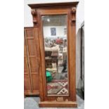 A late Victorian mahogany linen press chest of drawers, the mirrorfront door opening to reveal three