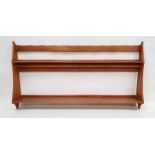 1970 Oliver Morel Cotswold School cherrywood wall rack, the top rail with scalloped edge, two