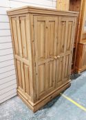 Contemporary pine two-door wardrobe, the doors opening to reveal fitted clothes rail, 153cm high x