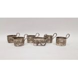 Set of six George V silver coffee can holders, pierced with swag decoration (one damaged)
