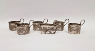 Set of six George V silver coffee can holders, pierced with swag decoration (one damaged)