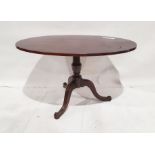 Early 19th century mahogany table, the oval top on turned baluster pedestal and reeded tripod