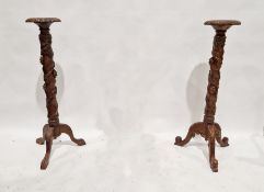 Pair of mahogany jardiniere stands, relief decorated with fruiting vines (2)