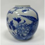 A Chinese blue and white ginger jar on stand, decorated with a traditional scene with peacock
