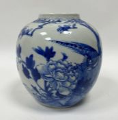 A Chinese blue and white ginger jar on stand, decorated with a traditional scene with peacock