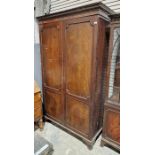 Mahogany two-door wardrobe with carved geometric decoration to the pediment, raised on splayed