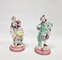 Pair of Meissen-style porcelain figures of a lady and gallant, each on pink and gilt circular