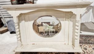 Early 20th century white painted overmantel mirror, the bevelled edged oval glass panel over a