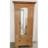 20th century pine single door wardrobe, the bevel edged glazed door opening to reveal hanging