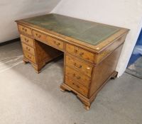 Burr walnut veneer twin pedestal desk with gilt tooled leather top, having a central long drawer
