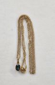 Gold-coloured metal and blue stone pendant set with oval stone, on fine gold-coloured metal chain