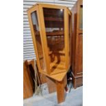 1970's teak corner cabinet, possibly by Ladderax or Staples, the single glazed door opening to