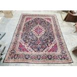 North East Persian blue ground Meshed carpet with graduated central floral medallion on floral field