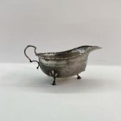Early 20th century silver sauceboat with scroll-shaped handle, on three spade feet, Birmingham 1918,