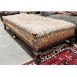 Mahogany daybed/footstool upholstered with scrolling floral fabric, raised upon six claw and ball