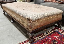 Mahogany daybed/footstool upholstered with scrolling floral fabric, raised upon six claw and ball