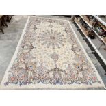 Central Persian Kashan cream ground carpet with large central floral medallion enclosed by hanging