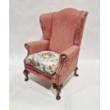 20th century pink upholstered wing back armchair raised on short cabriole feet, 114cm high