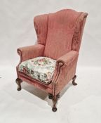 20th century pink upholstered wing back armchair raised on short cabriole feet, 114cm high