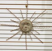 Wall-hanging metal sculpture of sun with smiling face, with wrought iron sun rays