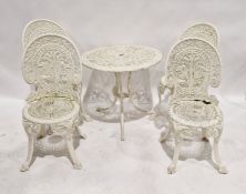 White painted cast aluminium circular garden table and four chairs with pierced decoration and a