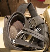 Assorted nylon head collars, leather and rubber reins, stirrup leathers, rubber girths and an