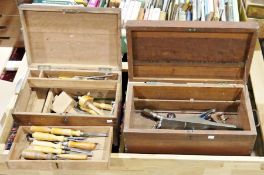 Three vintage wooden toolboxes containing assorted tools to include chisels, hammers, saws, files