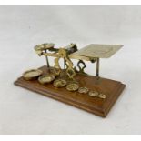 Set of late 19th century Sampson Mordan and Co. postal scales, with seven graduated weights on oak