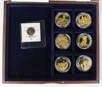 Two presentation wooden boxes comprising six silver plated commemoratives of the Great War and six