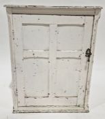 White painted cabinet with panelled cupboard door enclosing shelves, 76cm high x 61cm wide x 35.