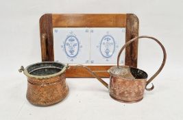 Wooden tea tray inlaid with a pair of delft-style tiles, an embossed copper plant watering can and a