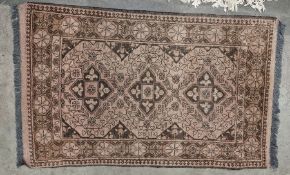 Eastern green ground rug with three central geometric medallions on a floral field, multiple
