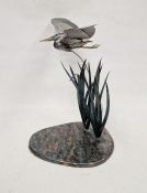 Metal sculpture of a heron flying amidst reeds, 'en tremblant', 58cm high