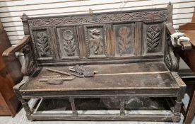 Oak carved settle, 100cm high x 143cm wide (not including missing pieces) (in need of restoration)