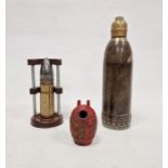 Decommissioned armour piercing round within a little display unit, a trench art  shell and a