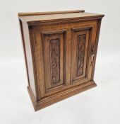 20th century oak wall cabinet with carved panel door enclosing shelves, 57cm high x 48cm wide x 25,