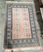 Pakistani hand knotted peach ground wool pile rug with two rows of six elephant foot guls,