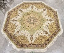 Modern octagonal green ground rug with central floral medallion on a floral field, single floral