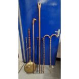 Brass lidded warming pan, two walking sticks made from bamboo, a carved wooden thumbstick, another