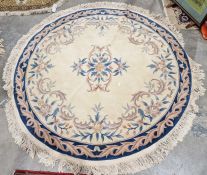 Large circular Chinese cream ground superwash rug with central floral medallion enclosed by floral