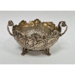 19th century foreign silver circular-shaped two-handled dish, repousse decorated with cherubs,