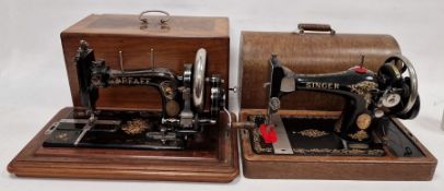 Early 20th century 'Singer' sewing machine under arched top cover and a 'Pfaff' sewing machine in