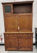 Arts & Crafts oak dresser, style of Liberty, the top left cupboard with leaded green glass door,