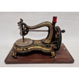 Late 19th century Jones hand sewing machine, decorated throughout with ornate gilt motifs on a black